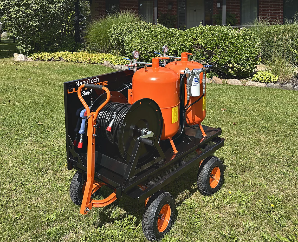 The NanoTech Ultimate 3 in 1 on its heavy-duty cart, parked on grass in front of a house.